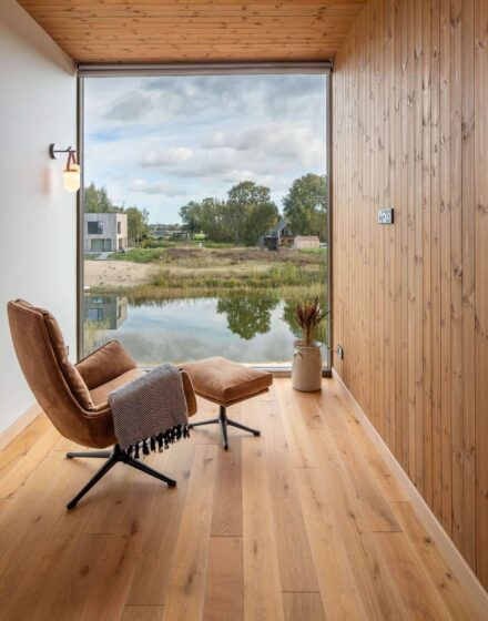 Nature inspired Coastal Interior Featuring Oak Wood Flooring, Earthy Colour Pallete and Captivating Forest Views