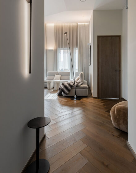 Sophisticated Simplicity: Herringbone Parquet Paired With Modern Velvet Doors