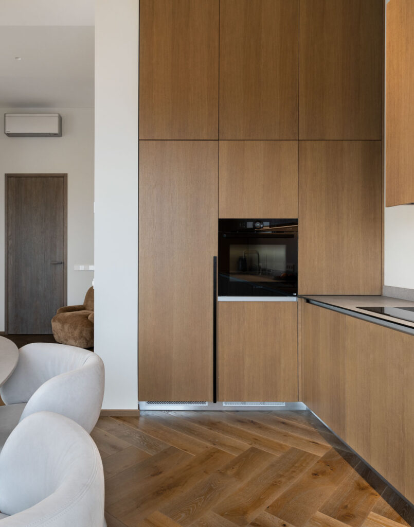 Sophisticated Simplicity: Herringbone Parquet Paired With Modern Velvet Doors