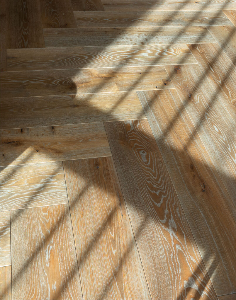 Sophisticated Simplicity: Herringbone Parquet Paired With Modern Velvet Doors